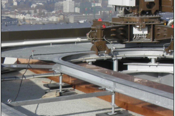 With free laid tracks, if appropriate for the project site and design of the machine, you can prevent drilling on the concrete and easier to install when compared with anchored track. 
